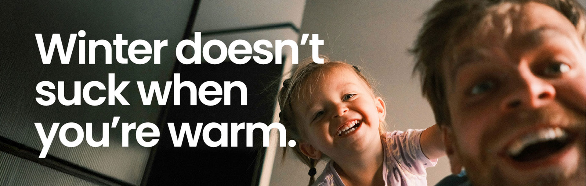 Dad and child inside a warm home with double glazed windows in winter